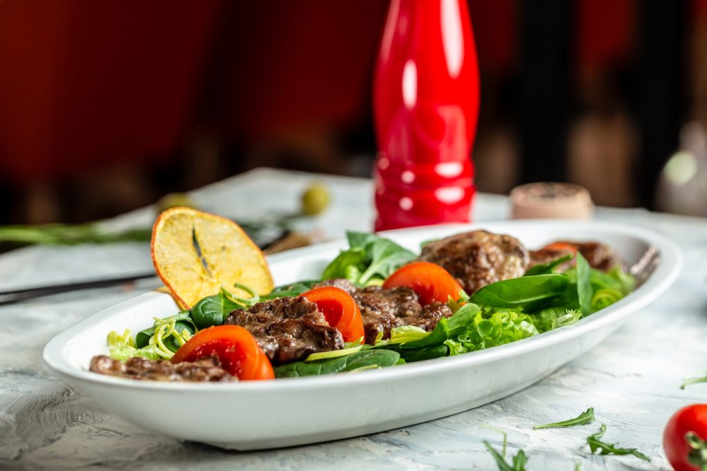 Baby spinach salad with beef liver and balsamic. Restaurant menu, dieting, cookbook recipe