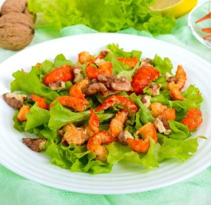 Light dietary spicy salad of lettuce, seafood (crawfish, shrimp) and walnuts